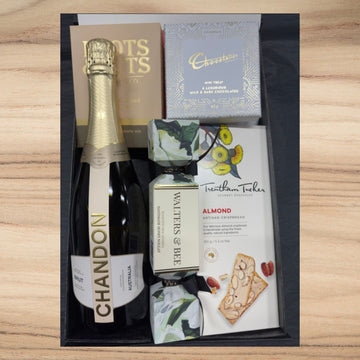 Luxury gift box with Chandon sparkling wine, gourmet almond crispbread, chocolate, honey nougat, and nuts mix