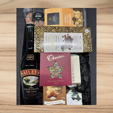 Gift box with Baileys Irish Cream, milk chocolate speckle, salted caramel cookies, honey coated popcorn, and coffee chocolate