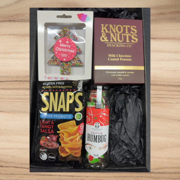 Festive snack gift box with Christmas tree chocolate, milk chocolate coated peanuts, vegan probiotic salsa snaps, and festive humbug candies