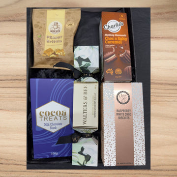 Gift box with Kelly's peanut brittle, Charlie's choc & salty caramel, cocoa treats milk chocolate, Walters & Bee nougat, and raspberry white choc biscuits