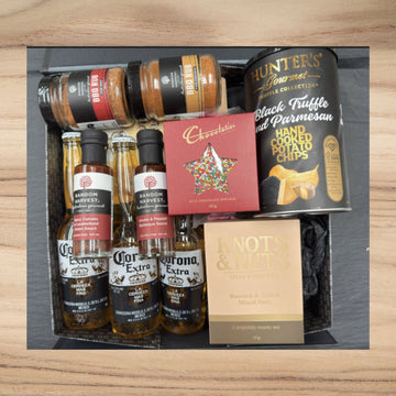 Gift box with Corona beer, BBQ rubs, Random Harvest sauces, Hunter's truffle potato chips, chocolate, and roasted mixed nuts