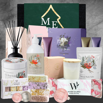 Collection of therapeutic bath and body products including hand lotion, scrub, bath salts, candles, soaps, lavender eye pillow, and reed diffuser