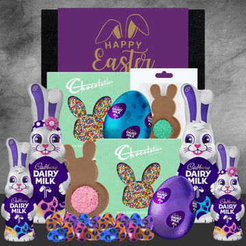 Cadbury Dairy Milk Easter eggs and chocolate bunnies on a gray background with 'Happy Easter' banner.