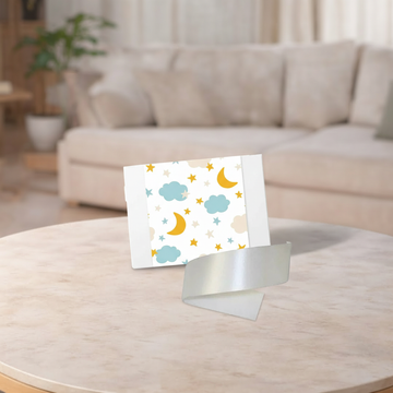 Card with cloud and moon design on a stand in a living room setting