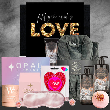 Gifting set with products and a 'All you need is LOVE' poster on a gray background