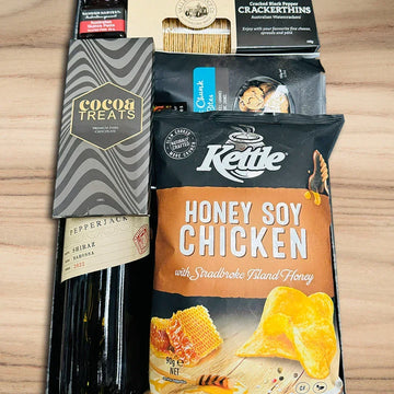 Assorted snacks including Kettle Chips and Cocoa Treats on a wooden surface