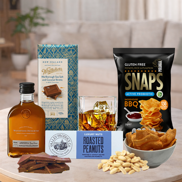 Snacks and drinks on a table with a blurred background of a living room.