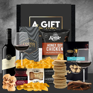 Assorted gourmet food items including wine, snacks, and coffee on a gray background with 'A Gift' box.