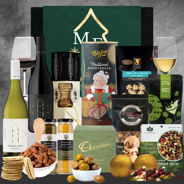 Christmas Gourmet gift basket with wine, snacks, and treats on a gray background