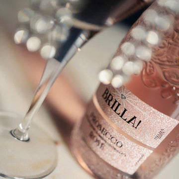 Bottle of Brilla Prosecco with a glass being filled, on a blurred background