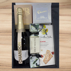 Luxury gift box with Chandon sparkling wine, gourmet almond crispbread, chocolate, honey nougat, and nuts mix
