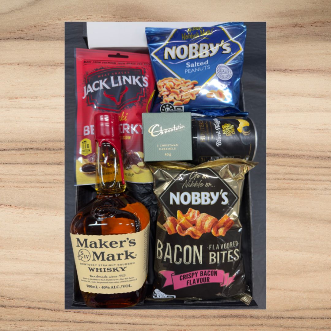 Gift box with Maker's Mark whisky, Jack Link's beef jerky, Nobby's salted peanuts, Nobby's bacon bites, Chocolatier caramels, and Black Pepper snacks