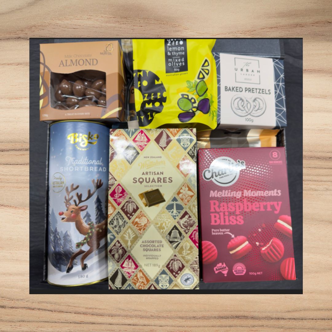 Gift box with milk chocolate almonds, lemon thyme olives, baked pretzels, shortbread, assorted chocolate squares, and raspberry bliss treats