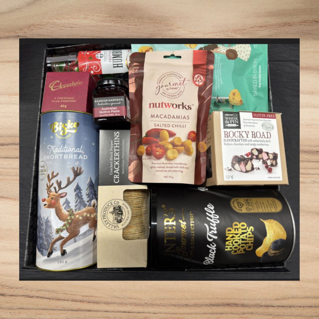 Gourmet gift box with shortbread, macadamias, truffle potato chips, rocky road, quince paste, and Christmas plum puddings