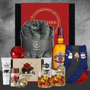 Holiday gift set with luxury gray bathrobe, Black Bear grooming kit, Chivas Regal whisky, festive Christmas socks, and ornaments