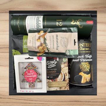 Christmas gift box with Glenfiddich whisky, macadamia nuts, truffle potato chips, gluten-free lavosh, and festive tree cookie