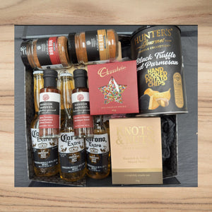 Gift box with Corona beer, BBQ rubs, Random Harvest sauces, Hunter's truffle potato chips, chocolate, and roasted mixed nuts