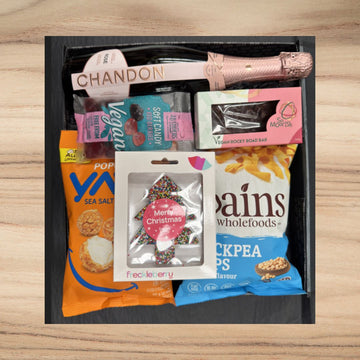 Gift box with Chandon rosé sparkling wine, vegan candy, vegan rocky road bar, sea salt popcorn, chickpea chips, and Christmas tree chocolate