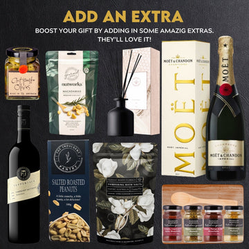 Gift set with wine, snacks, and other items on a black background