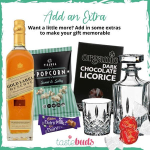 Gift set with Johnnie Walker whiskey, sweet & salty popcorn, dark chocolate licorice, Cadbury Dairy Milk, and crystal glassware