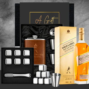 Alcohol gift set with Johnnie Walker Gold Label Reserve whisky, hip flask, and bar accessories on a gray background.