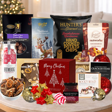 Assorted Christmas-themed snacks and treats on a table with festive decorations.