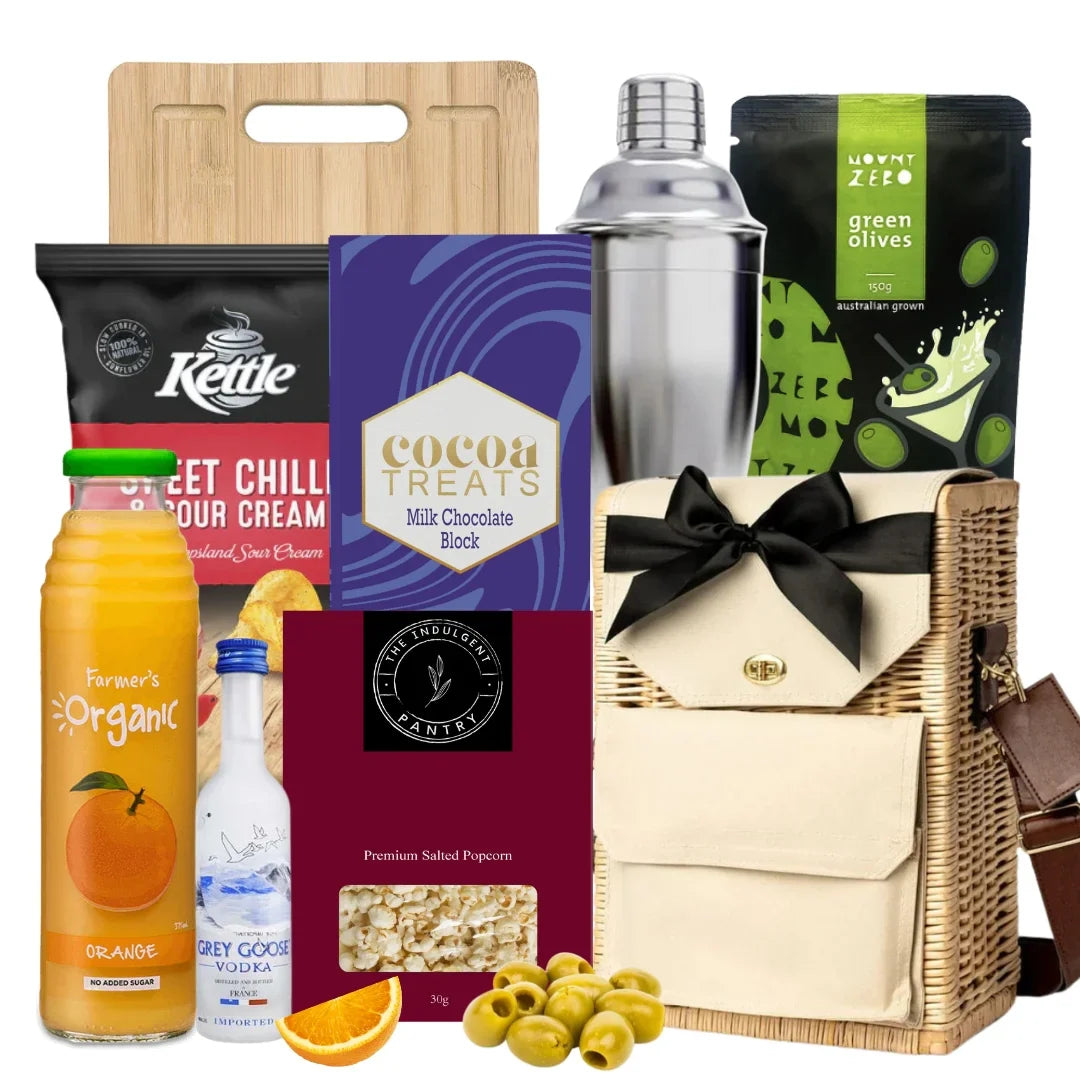 Assorted food items including a bottle, olives, and a basket with a gift on a white background