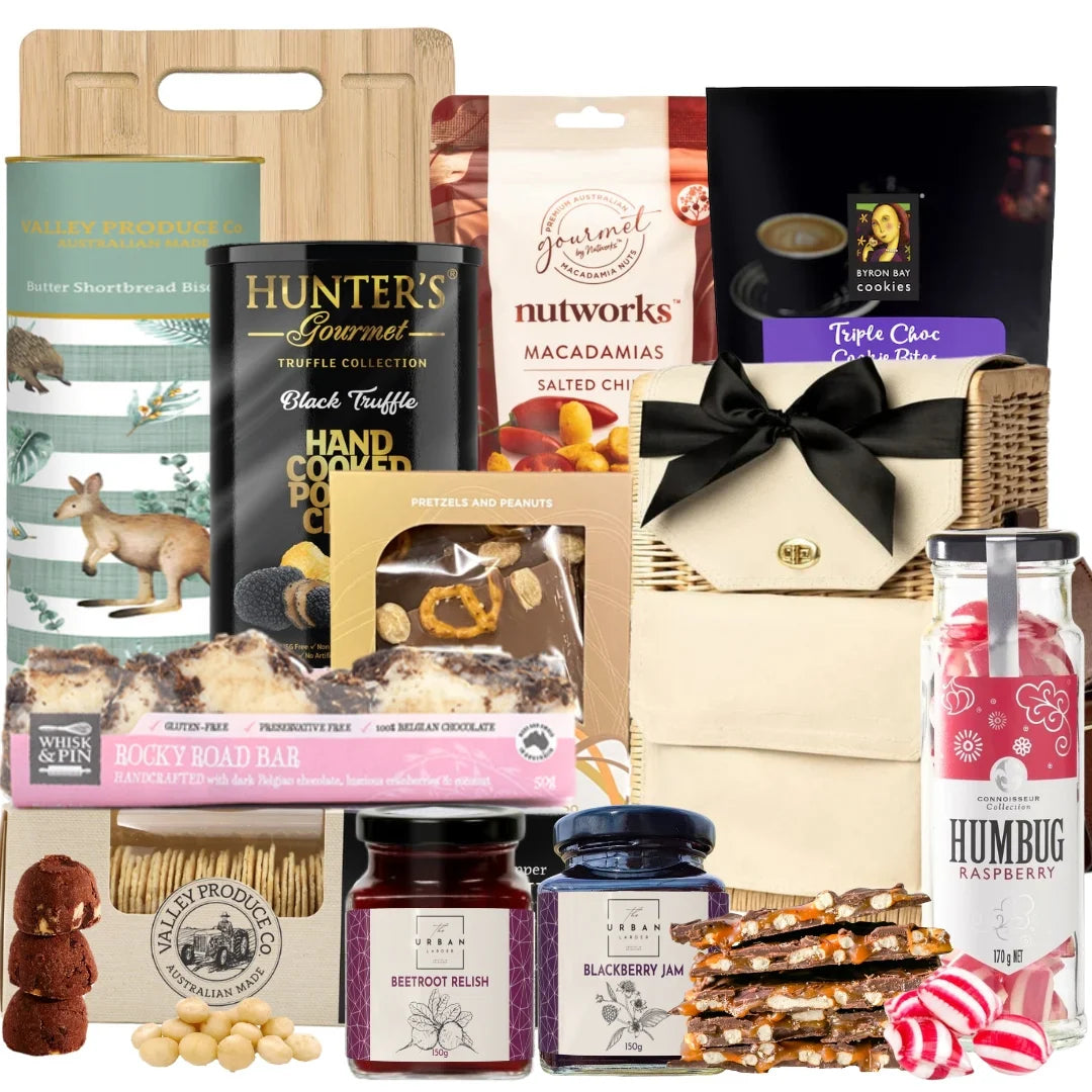 Assorted gourmet food and treat gift set with a variety of products including chocolate, nuts, and jam.