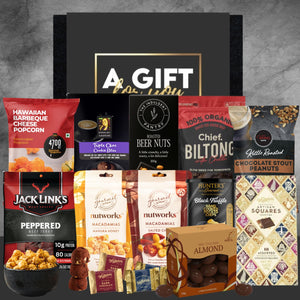 Assorted gourmet snacks in a gift box with visible brand names on packaging.