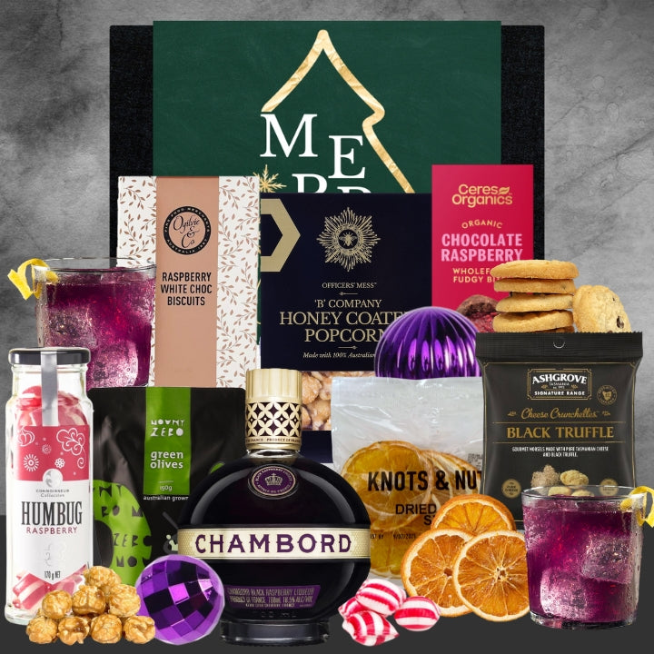 Assorted gourmet items including a bottle of Chambord, cookies, and drinks on a gray background.