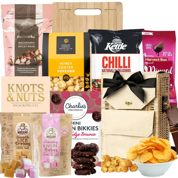 Assorted snacks and treats including popcorn, cookies, and chocolate bars on a white background