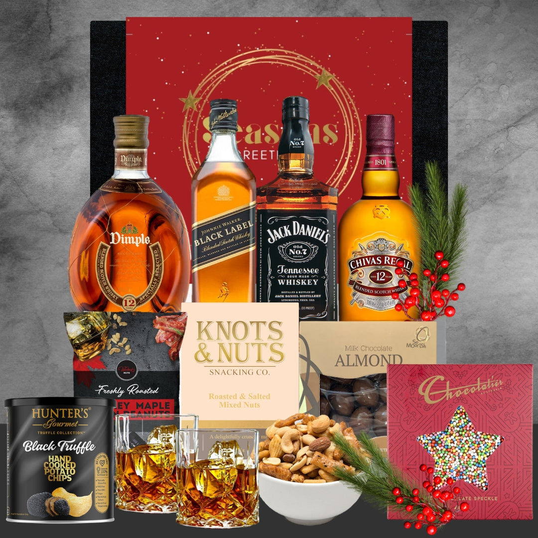 Assorted whiskey bottles, snacks, and a card on a Christmas decorative background