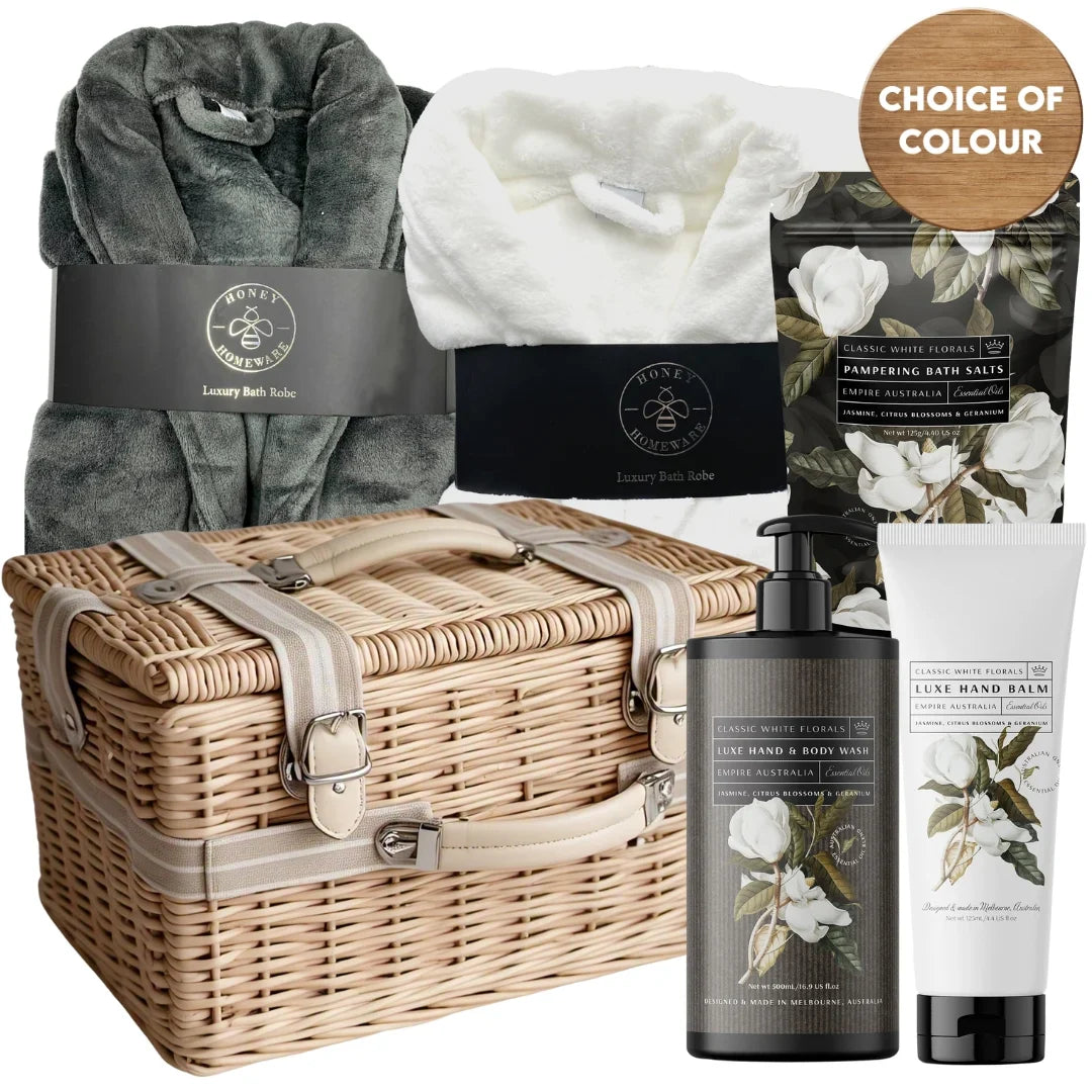 Bath and body gift set with wicker basket, robe, and skincare products on a white background.