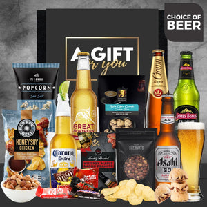 Gift basket with beer bottles, snacks, and popcorn against a dark background.