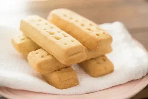 Three shortbread cookies on a white napkin