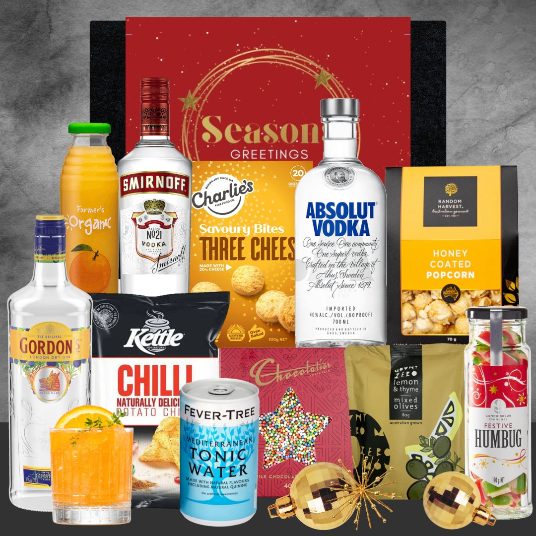 Collection of alcoholic beverages and snacks with a festive 'Christmas Season Greetings' box.