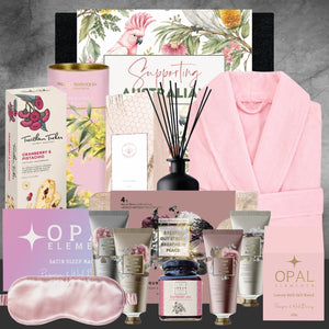Collection of beauty products and a pink robe on a gray background