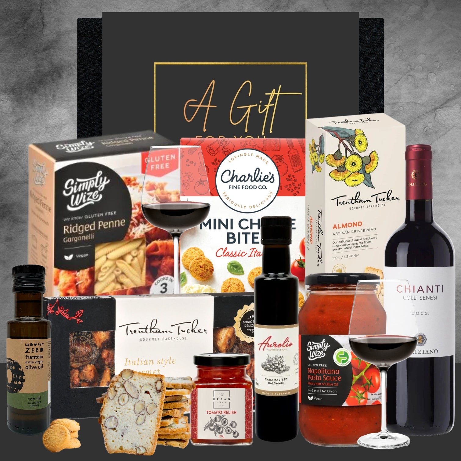 Collection of food products including wine, pasta, and sauces on a gray background