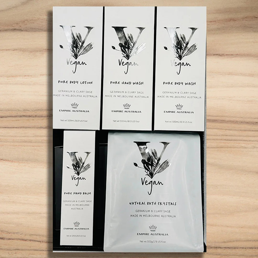 Set of vegan skincare product packaging on a wooden surface