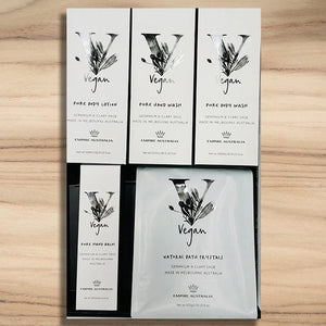 Set of vegan skincare product packaging on a wooden surface