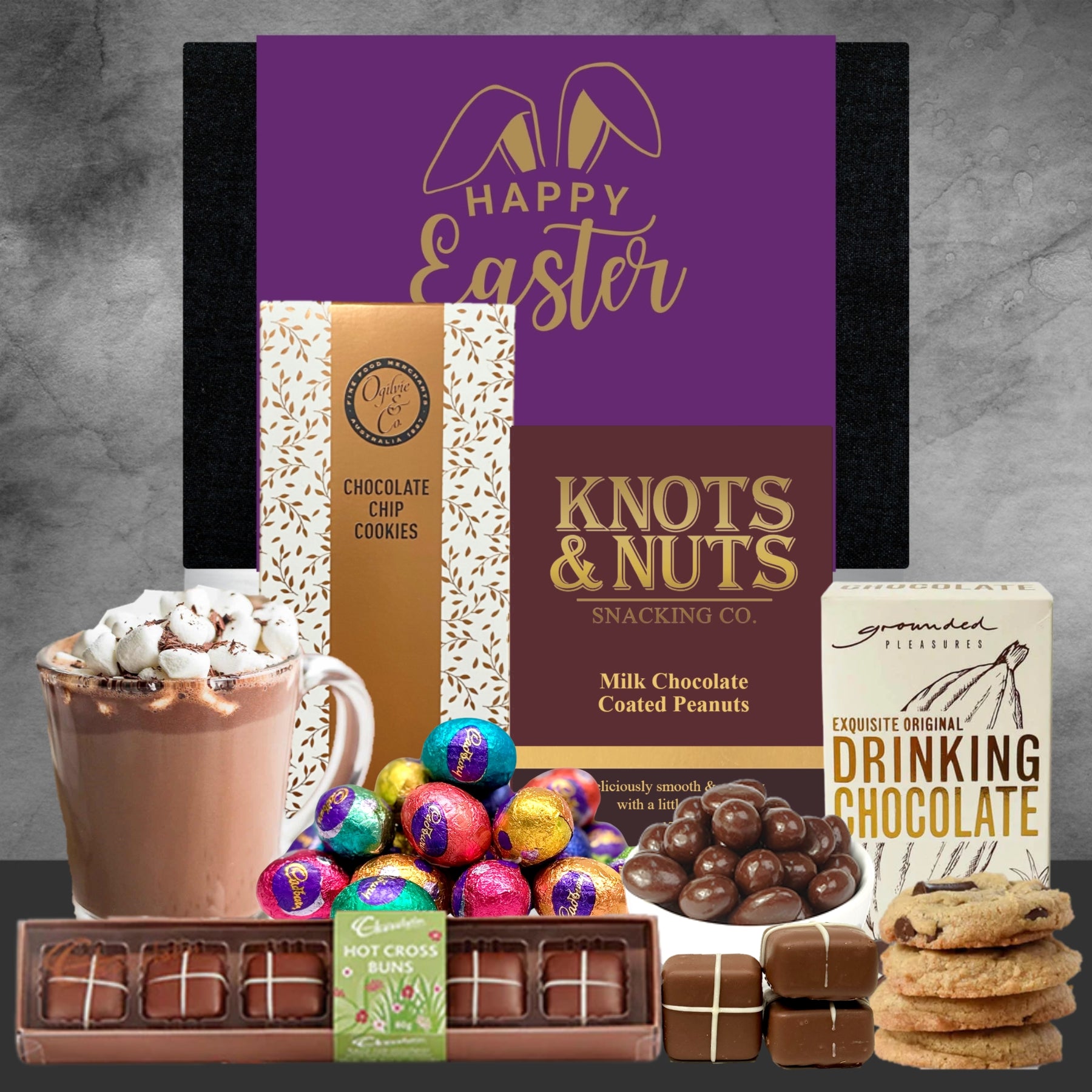Easter gift basket with snacks and treats on a gray surface