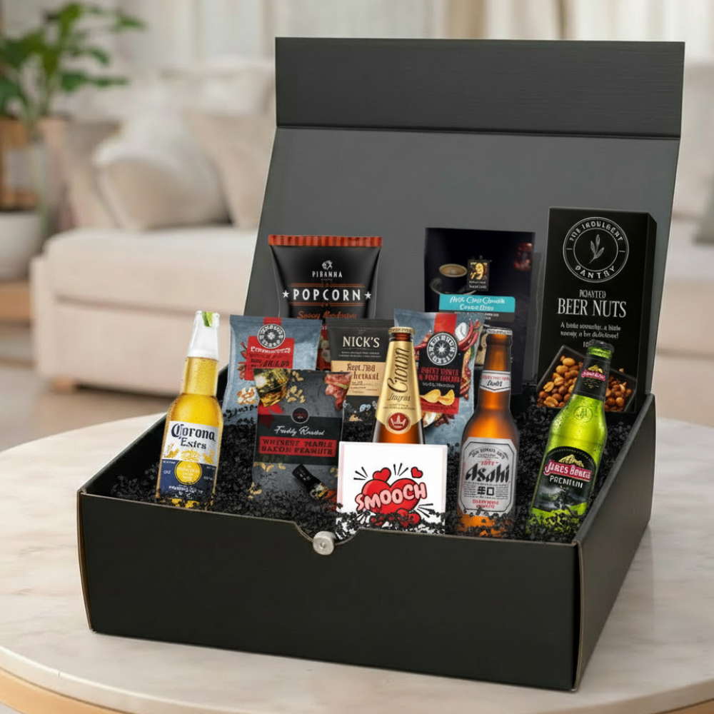 Gift Box with beer, snacks, and other items on a table in a living room setting.