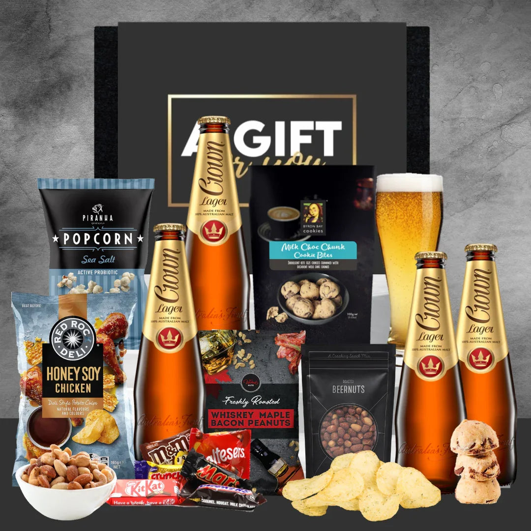 Gift set with beer, snacks, and candies on a gray background