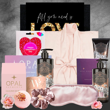 Gifting set with skincare products, bath bombs, and a sleep mask on a textured gray background.