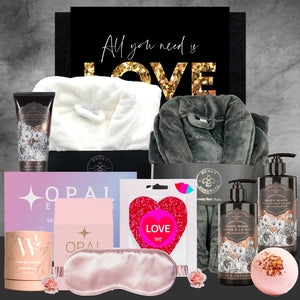 Gifting set with towels, skincare products, and decorative items on a gray background.