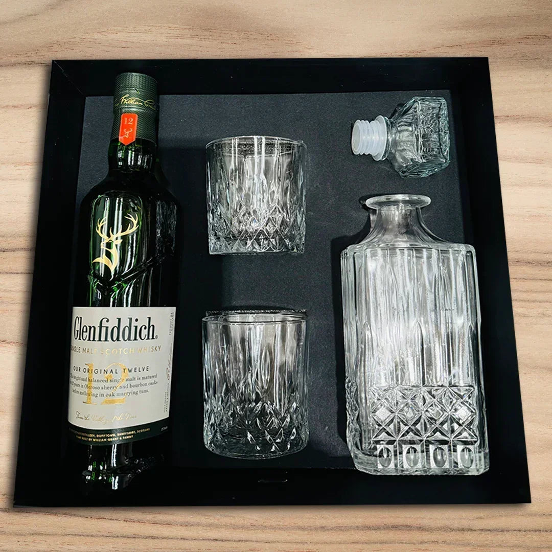 Glenfiddich bottle with glasses and decanter set on a black tray