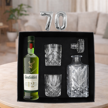 Glenfiddich whisky bottle with glasses and decanter set in a box, celebrating a 70th birthday.