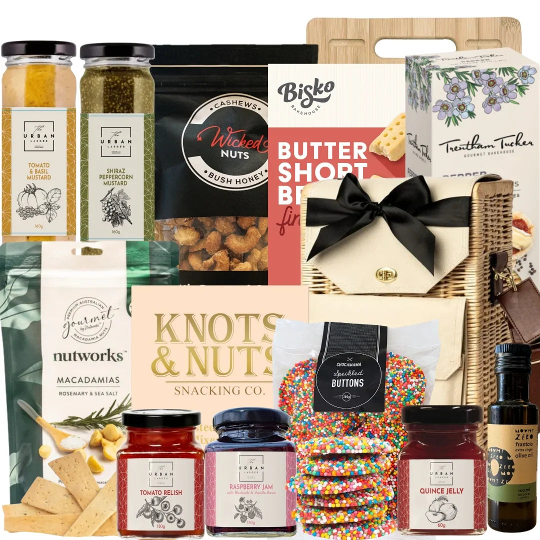 Assorted gourmet food items including jars, boxes, and a cutting board with a bow.