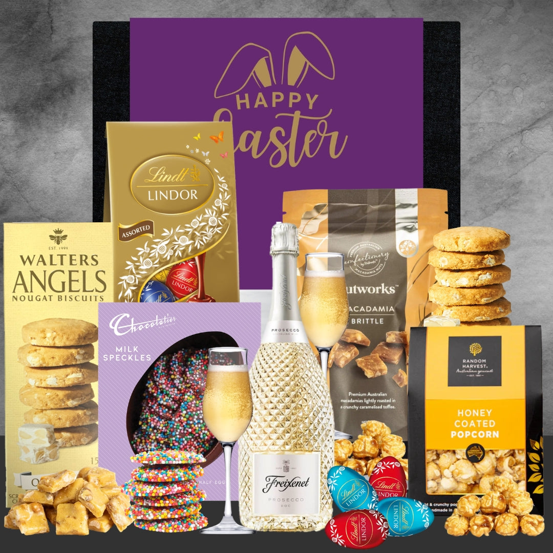 Gourmet Easter basket with chocolate, cookies, and champagne on a gray background