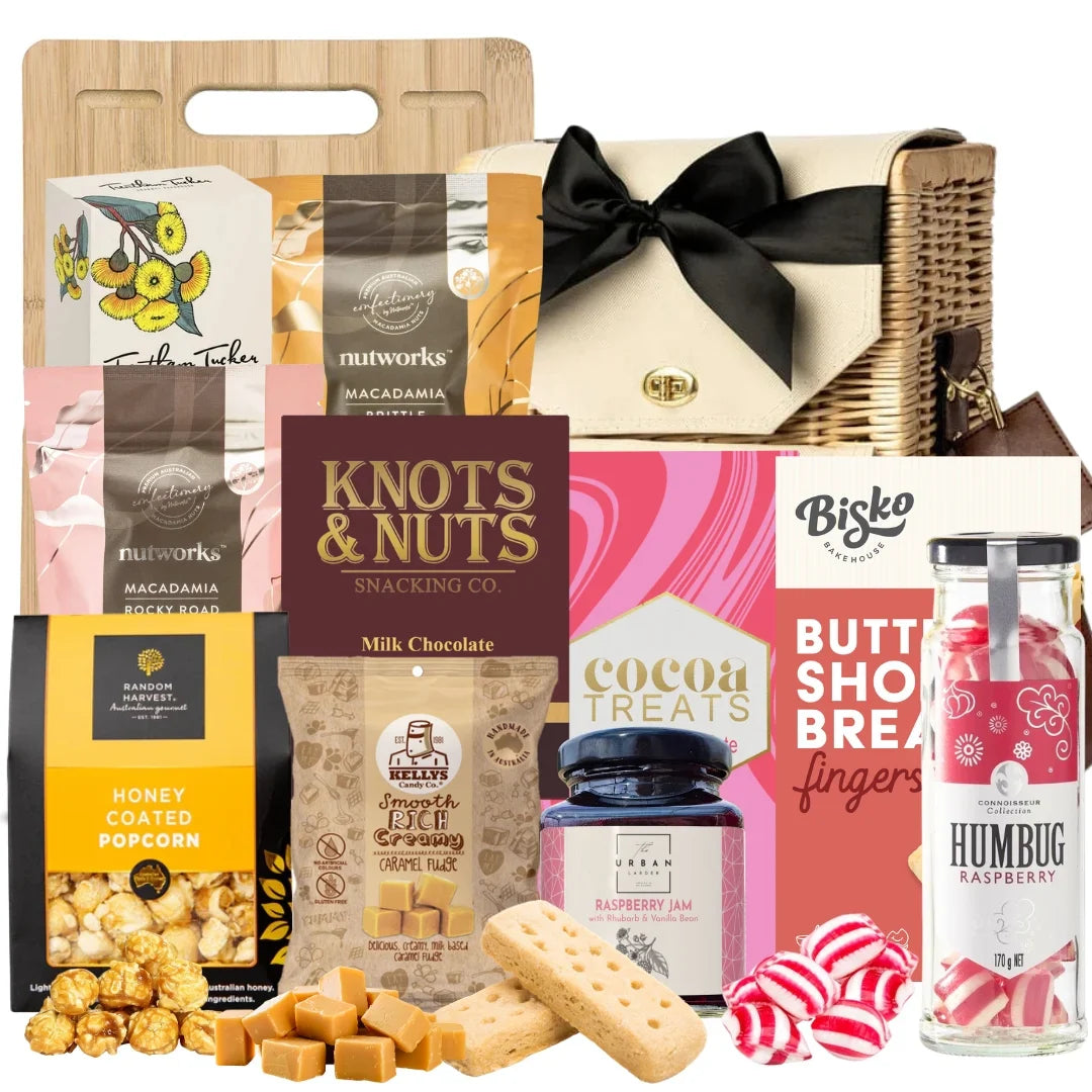 Assorted snack and treat items including a basket, chocolate, cookies, and candies on a white background.